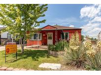 Charming red home with landscaped front yard and 'coming soon' sign under sunny skies at 753 S Utica St, Denver, CO 80219