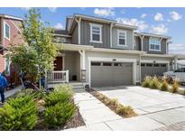 Charming two-story townhome with a two-car garage and well-maintained landscaping at 9503 Richfield St, Commerce City, CO 80022