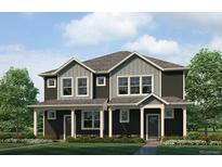 Beautiful townhome featuring black siding, gray accents, and a well-maintained lawn at 1372 S Boston Ct # A, Denver, CO 80247
