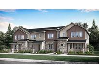New townhome construction featuring a stone and siding facade, covered porch, and professionally landscaped front yard at 718 N Bently St, Watkins, CO 80137
