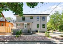Modern two-story home with gray siding, black-framed windows, and landscaped front yard at 4640 W 39Th Ave, Denver, CO 80212