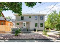 Charming two-story home featuring a welcoming front porch and well-kept landscaping at 4640 W 39Th Ave, Denver, CO 80212