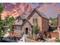 Charming two-story home with stone accents, a landscaped front yard, and an inviting entrance at 507 Ulster Way, Denver, CO 80230