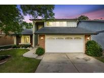 Charming two-story home with a brick facade and well-maintained lawn and a two car garage at 3889 S Fraser St, Aurora, CO 80014