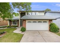 Charming home featuring a two-car garage, brick accents, and a well-maintained front yard at 3889 S Fraser St, Aurora, CO 80014
