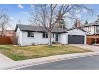 Charming one-story home with a well-maintained lawn and two car garage at 13586 W Warren Cir, Lakewood, CO 80228