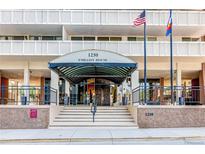 Embassy House entrance featuring flags and well-maintained stairs and awning at 1250 N Humboldt St # 202, Denver, CO 80218