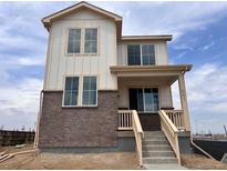 Charming two-story home boasts a blend of brick and siding, complemented by bright windows and a welcoming front porch at 5479 N Elk St, Aurora, CO 80019