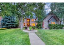 Brick two-story house with a landscaped lawn and walkway at 3351 Oak St, Wheat Ridge, CO 80033