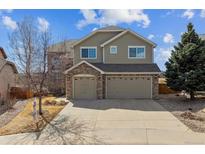 Charming two-story home features a brick-accented three-car garage and manicured landscaping at 1022 Orion Way, Castle Rock, CO 80108