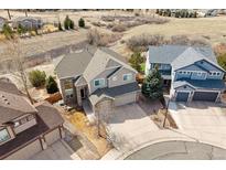 Charming two-story home with a three-car garage and well-manicured front yard at 1022 Orion Way, Castle Rock, CO 80108