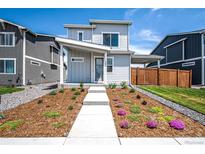 Charming two-story home with a modern design and beautifully landscaped front yard at 260 E 4Th St, Berthoud, CO 80513