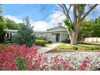 Charming single-story home with a stone landscaped front yard and mature trees offering a serene curb appeal at 41 Skyline Dr, Wheat Ridge, CO 80215