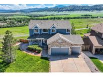 Stunning two-story home with a three-car garage and beautiful mountain views at 8915 S Field Ct, Littleton, CO 80128