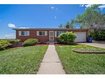 Charming brick ranch home with a well-maintained lawn and mature landscaping in a desirable neighborhood at 12024 W Maryland Dr, Lakewood, CO 80228