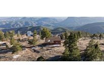 Charming mountain home featuring stunning panoramic views of the surrounding landscape at 18645 Rocky Top Trl, Littleton, CO 80127