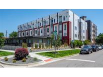 Modern condo building features a landscaped lawn with colorful plantings on a sunny day at 2741 W 28Th Ave # 2, Denver, CO 80211