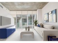 Bright living room featuring modern decor, large windows, and comfortable seating arrangement at 891 14Th St # 1506, Denver, CO 80202