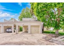 Charming home featuring a one-car garage, covered parking space, and mature trees in a well-maintained neighborhood at 1519 S Sable Blvd # C, Aurora, CO 80012