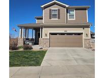 Charming two-story home featuring stone accents, a covered porch, and well-maintained landscaping at 23831 Eagle Bend Ln, Parker, CO 80138