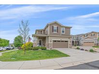 Charming two-story home with a well-manicured lawn, inviting curb appeal, and a two-car garage at 23831 Eagle Bend Ln, Parker, CO 80138