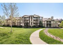 Attractive multi-story condo building with well-maintained landscaping and inviting walkway at 7423 S Quail Cir # 1533, Littleton, CO 80127