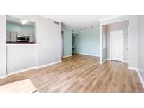 Spacious living room featuring wood-style floors and an open floor plan at 7423 S Quail Cir # 1533, Littleton, CO 80127