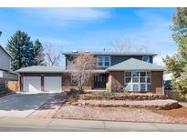 Charming two-story home with brick accents, a two-car garage, and a well-maintained front yard at 7746 S Harrison Cir, Centennial, CO 80122