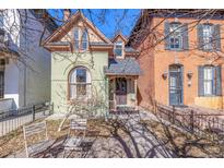 Charming Victorian-style home with a unique arched window and inviting front porch at 2543 Stout St, Denver, CO 80205