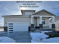 Charming single-story home featuring stone accents, a front porch, and a modern garage door with glass panels at 42976 Colonial Trl, Elizabeth, CO 80107