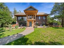 Charming two-story home with a brick walkway, a balcony and a well maintained yard at 776 Hilltop Rd, Palmer Lake, CO 80133