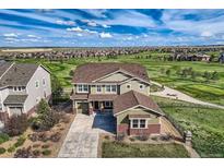 Beautiful two-story home overlooking a manicured golf course and lush landscaping at 7658 S Country Club Pkwy, Aurora, CO 80016