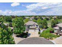Inviting two-story home with a three-car garage and beautiful landscaping at 9278 E Aspen Hill Pl, Lone Tree, CO 80124
