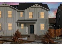 Two-story home with light gray siding, shutters, and a dark blue front door at 255 Mayfly Ln, Berthoud, CO 80513