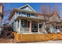 Charming two-story home features a welcoming front porch and a picket fence at 3353 Wabash St, Denver, CO 80238