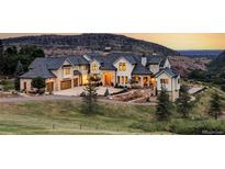Luxury home with mountain views, expansive driveway, and landscaped grounds at 9356 Cherrywood Trl, Littleton, CO 80127
