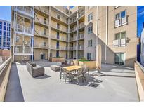 Spacious outdoor courtyard with contemporary furniture and views of the building's architecture at 290 W 12Th Ave # 205, Denver, CO 80204