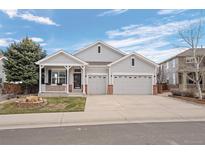 Charming single-Gathering home with a welcoming front porch and a well-maintained, green lawn at 1757 Baguette Dr, Castle Rock, CO 80108