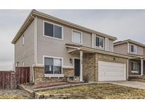 Charming two-story home featuring brick accents, a two-car garage and a well-maintained front lawn at 21568 E 38Th Pl, Denver, CO 80249
