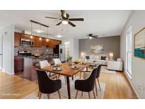 Open-concept living space with wood floors, kitchen, dining area, and living room at 925 Elm St, Denver, CO 80220