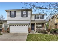 Charming two-story home featuring a well-manicured lawn and attached two car garage at 14245 Corrine Ct, Broomfield, CO 80023