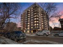 Stunning exterior view of a high-rise building with balconies, complemented by surrounding trees and street at 1150 Vine St # 201, Denver, CO 80206