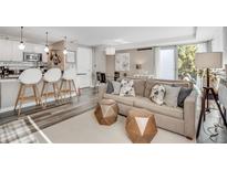 Bright, modern living space with breakfast bar, stylish decor, and balcony access at 1150 Vine St # 201, Denver, CO 80206