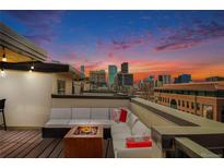 Spacious rooftop deck with city views and fire pit at 2438 Welton St, Denver, CO 80205