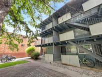Apartment building exterior featuring balconies, stairs, and bike parking at 2401 S Gaylord St # 206, Denver, CO 80210