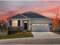 Charming single-Gathering home with a well-manicured lawn, two-car garage, and stone detailing at 1975 S Coolidge Way, Aurora, CO 80018