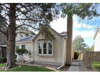 Charming home featuring a brick chimney, mature trees, and a well-maintained front yard at 9610 W Chatfield Ave # F, Littleton, CO 80128