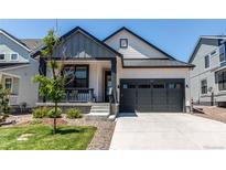 Charming single-Gathering home with a well-manicured lawn and inviting gray two-car garage at 39167 Braxton Ln, Elizabeth, CO 80107