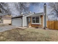 Charming home featuring a brick facade, two-car garage, and cozy front entry at 4542 S Quintero St, Aurora, CO 80015