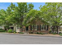 Charming brick and siding home featuring lush landscaping and a welcoming entrance at 4545 S Monaco St # 243, Denver, CO 80237